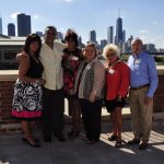 A group photo of the Board in front of a Chicago skyline